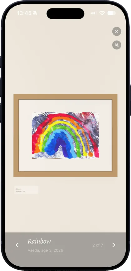 A child's rainbow painting, framed on a gallery wall