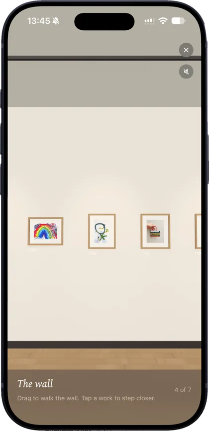 A wall of framed children's drawings